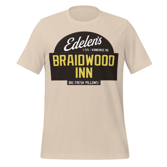 A soft cream colored 70s style Edelen's Braidwood Inn t-shirt, referencing the Braidwood III motel famous from the movie 'Planes, Trains & Automobiles", visited by characters Neal (played by Steve Martin) and Del (played by John Candy). Shirt also says the location, "I-55 / Kankakee Rd." and an advertisement: "Big Fresh Pillows!"