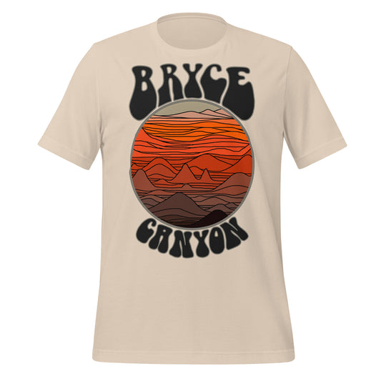 A soft cream Bryce Canyon t-shirt with an image of orange and brown colored canyons and mountains, as if the sun is setting. References the famous national park in Southern Utah, perfect for hiking and a popular tourist destination.
