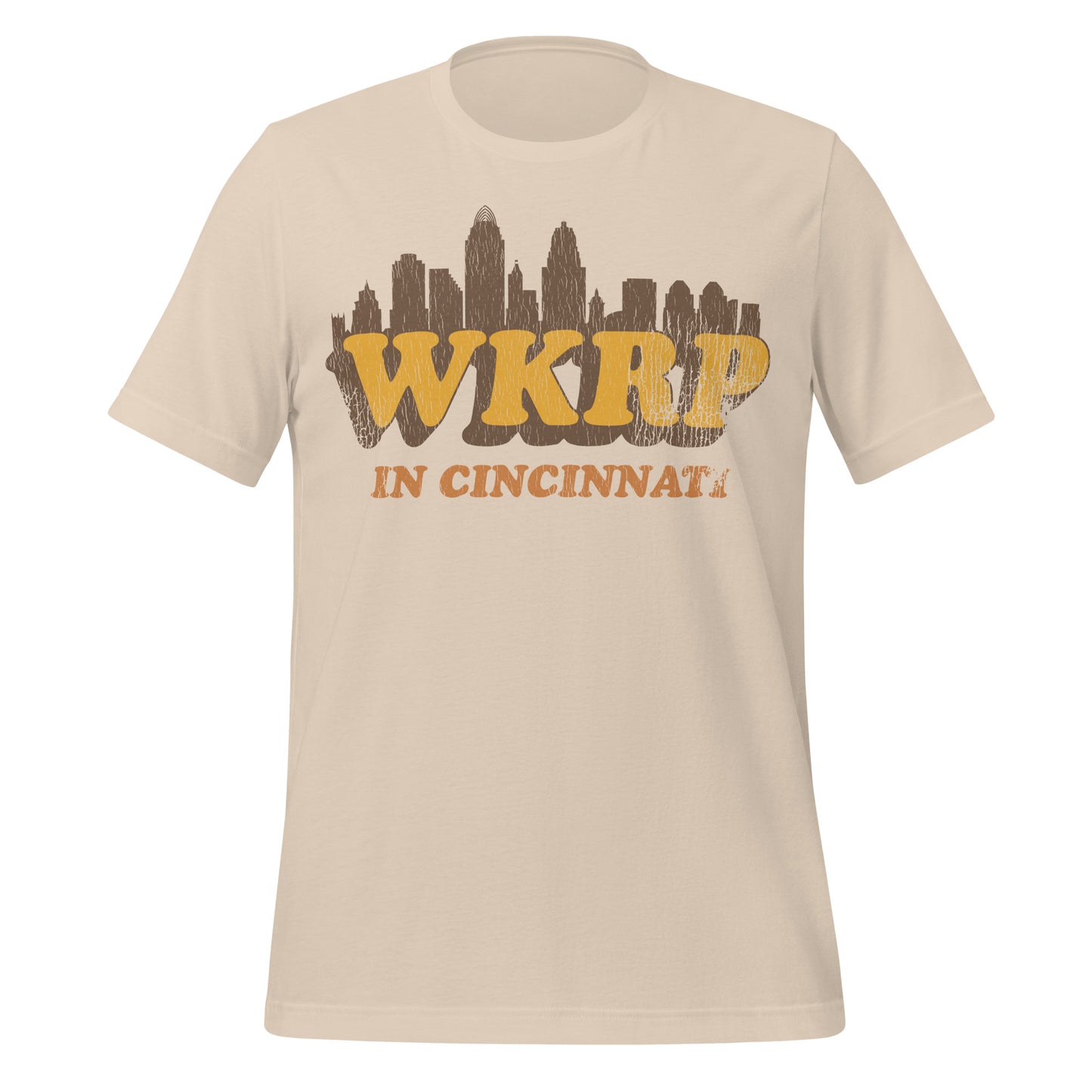 A soft cream vintage t-shirt that says WKRP In Cincinnati with an image of the Ohio city's skyline. References the sitcom which ran for 4 seasons.