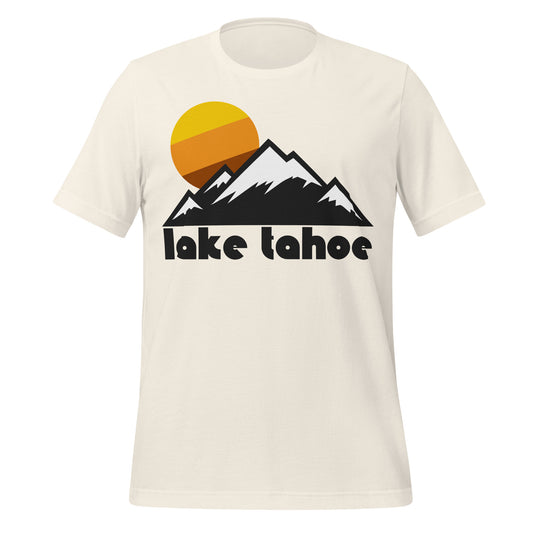 A 70s style vintage white colored t-shirt that reads "Lake Tahoe" under a the image of a mountain range with snowy peaks and a striped yellow/orange/brown sun setting in the distance. References the freshwater lake in the Sierra Nevada Mountain Range that straddles the Nevada and California border, popular for tourists and resort goers as well as skiers and snowboarders.