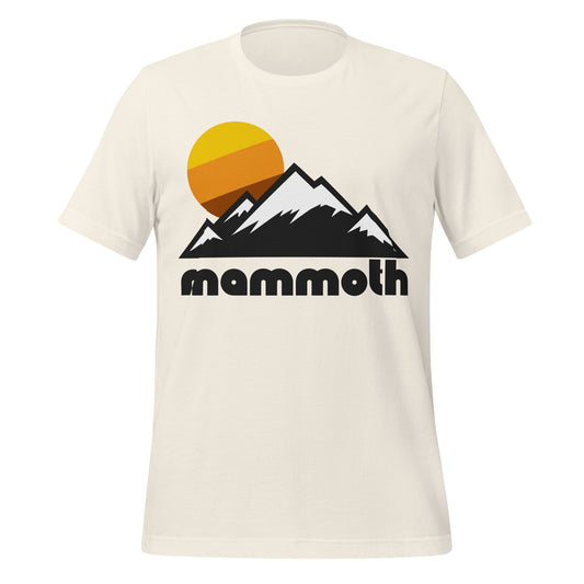 A vintage white colored 80s style t-shirt that says "Mammoth" under the image of a snow covered mountain range and a warm toned sun. References California's popular skiing and snowboarding destination Mammoth Mountain, located in the town of Mammoth Lakes, which has incredible winters and summer hiking trails.