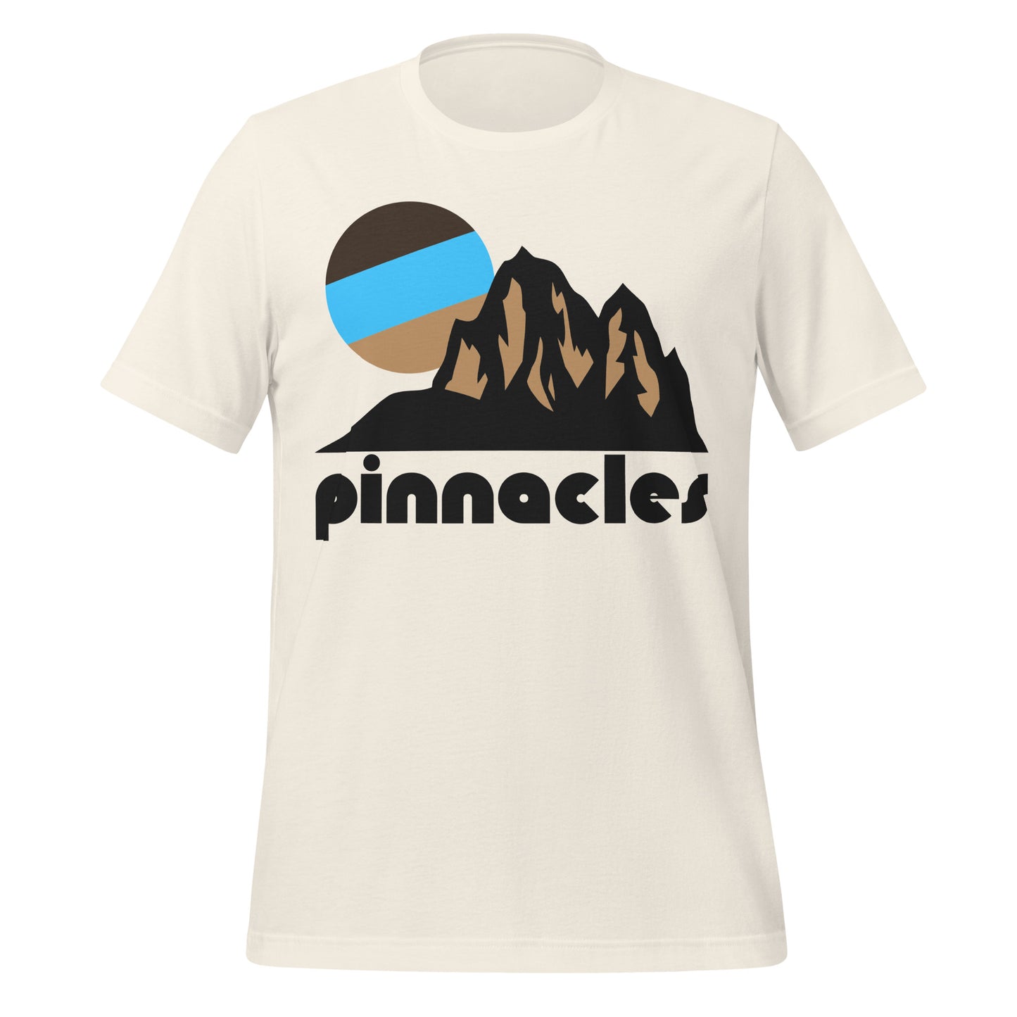 A vintage white colored souvenir 'Pinnacles' t-shirt with an image of a mountainous landscape and a brown/blue sun rising above the rock formations. In reference to California's Pinnacles National Park, famous for its brilliant hiking trails and incredible rock climbing opportunities, especially on the special rock formations known as pinnacles, as well as its famous talus caves.