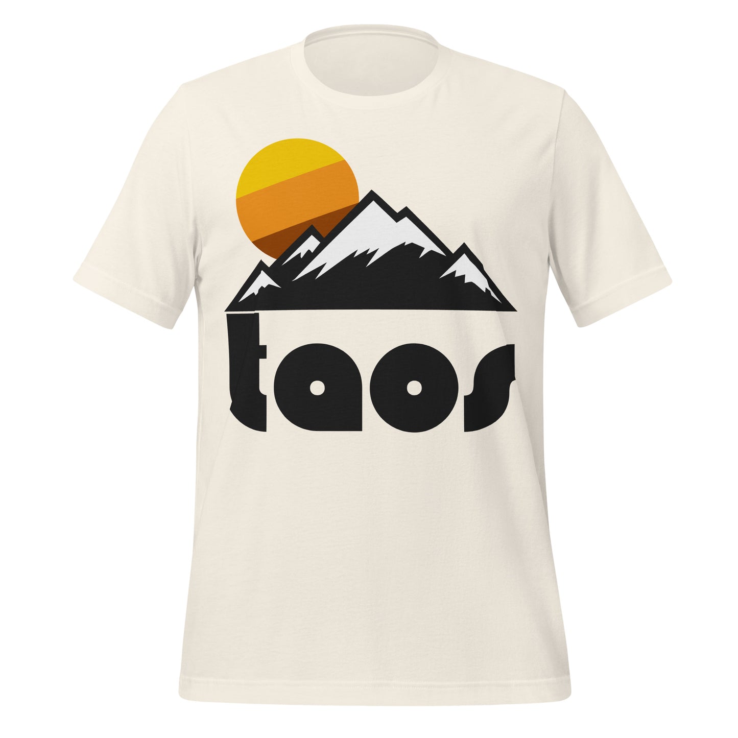 An 80s style, souvenir vintage white colored shirt that says "taos" in bold, black letters, referencing New Mexico's world famous Taos Mountain and Taos Ski Valley and resort in the town that was originally settled as a mining town. The shirt has the image of multiple mountain peaks with snowy tops and a picturesque sun setting in the distance.