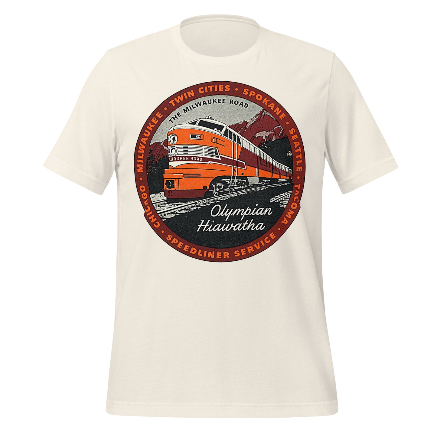 A retro Olympian Hiawatha t-shirt, referencing the Speedliner Service passenger trains operated on The Milwaukee Road, a large railroad network that connected cities across the states, including Tacoma, Seattle, Spokan, the Twin Cities, Milwaukee, and Chicago. Image of an orange, red, and white train chugging along tracks, with the name "Milwaukee Road", mountains and forests in the background.