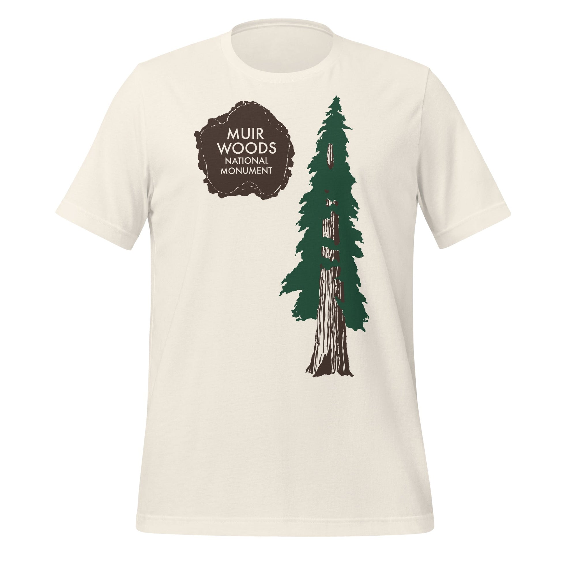 A vintage white 80s style tourist t-shirt that says "Muir Woods National Monument" on top of a brown paw print next to a beautiful pine tree, part of California's Golden Gate National Recreation Area.