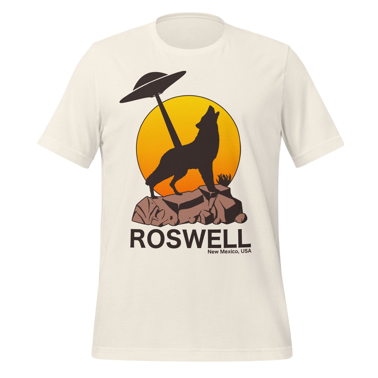 A vintage white retro 70s style Roswell t-shirt from New Mexico, USA with an image of a wolf howling to the moon on top of a brown rock, an orange and yellow hombre sun setting in the distance and a UFO shining a light down to the wolf. Referencing the infamous Roswell UFO Incident and The Roswell Report.