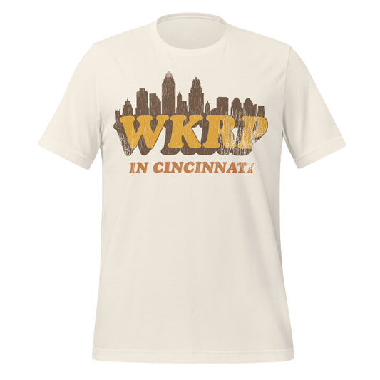 A retro 70s style white t-shirt that says WKRP In Cincinnati with the skyline in Ohio. Refers to the sitcom TV series which premiered in 1978 on CBS and ran until 1982.