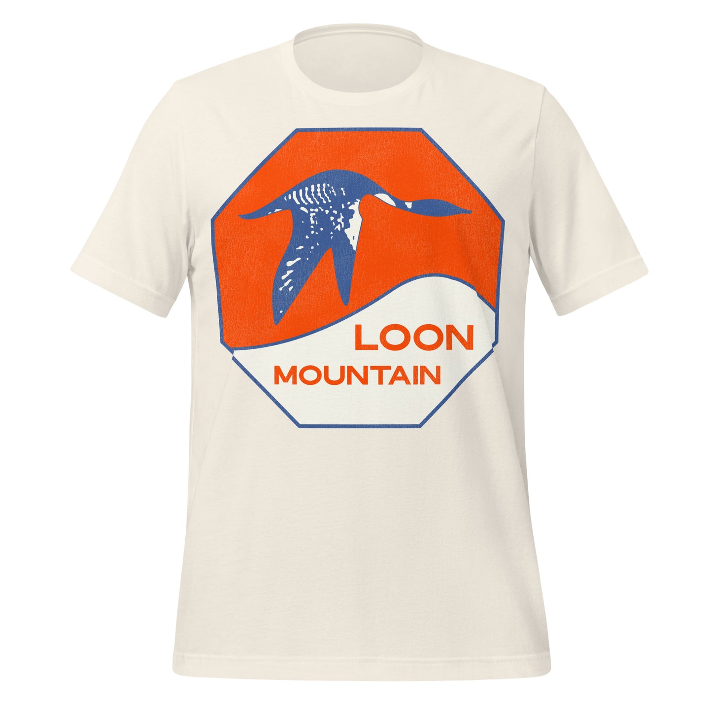 A white short sleeve tourist t-shirt that says Loon Mountain with a blue loon flying above a snowy hill with an orange sky backdrop on an octagon.