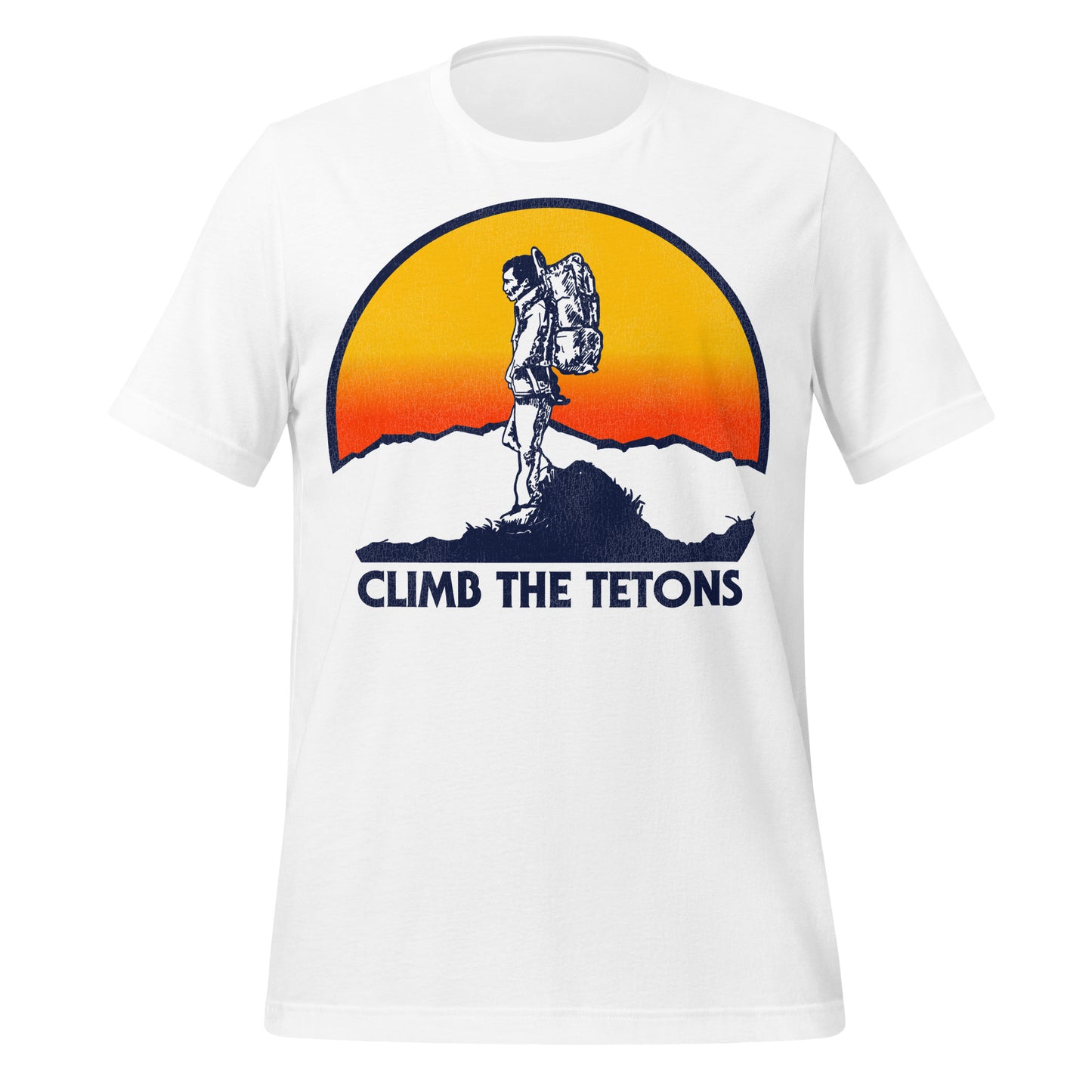 A short sleeve Grand Tetons white retro t-shirt which says "Climb the Tetons" with an image of a man carrying a backpack at the top of a craggy mountain, clouds and an hombre yellow and red setting sun behind him.