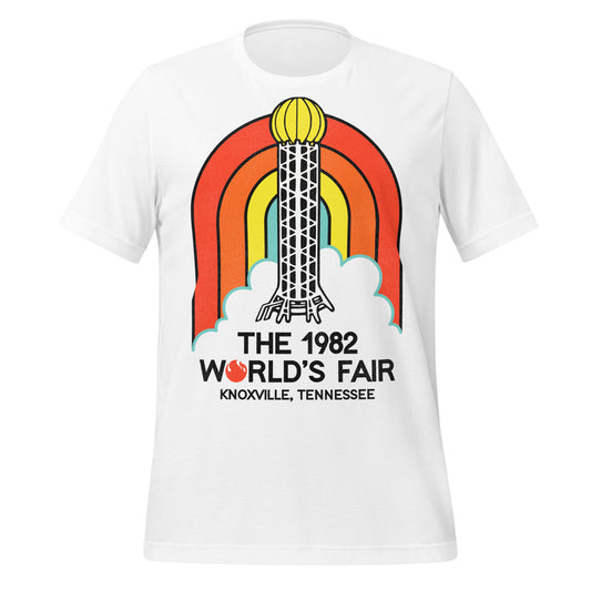 A white 80s style retro t-shirt that says  "The 1982 World's Fair" from "Knoxville, Tennessee" with a fire logo for the "O". Has an image of a red, orange, yellow, and blue rainbow and the Sunsphere steel tower which was a restaurant and observation deck. The fair's theme was "Energy Turns the World".