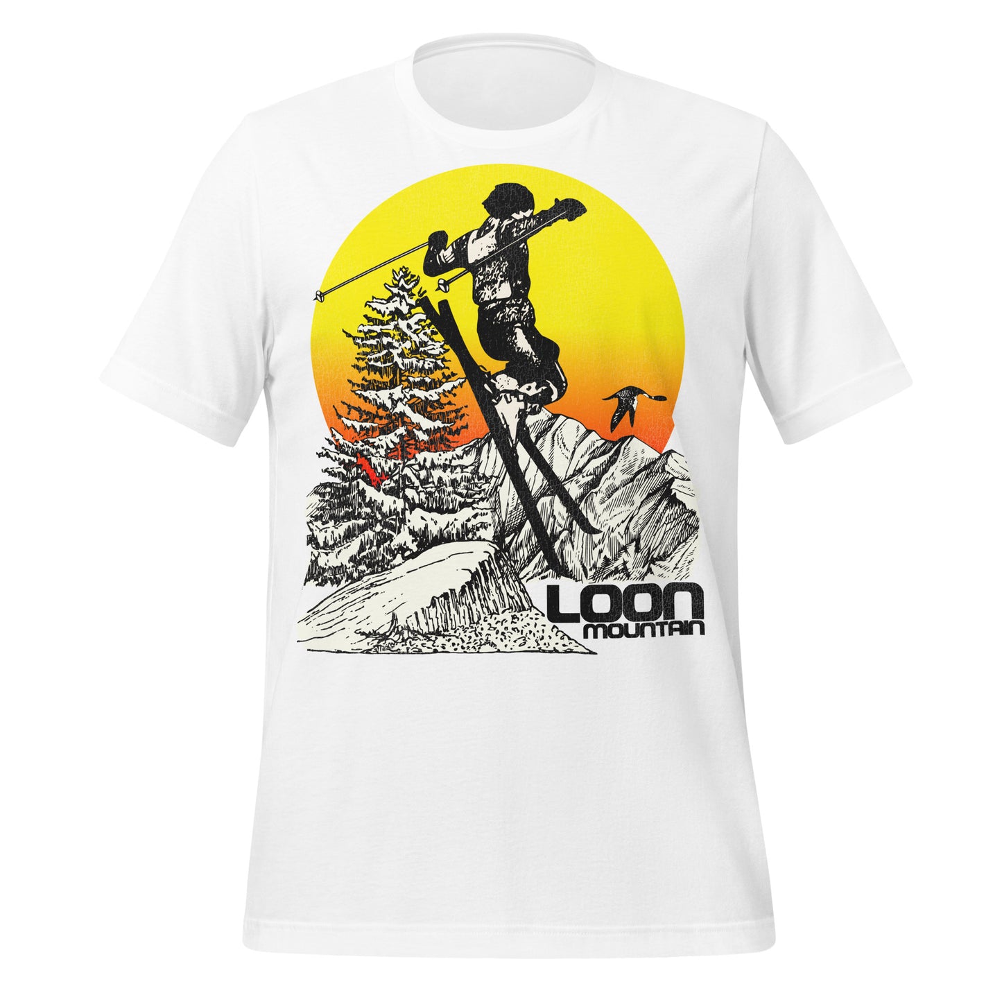 A white tourist t-shirt from Loon Mountain Resort in Grafton County, New Hampshire showing a skier in the air flying past cliffs, snowy mountains, and alpine trees beside a loon bird against an orange and yellow sunrise.