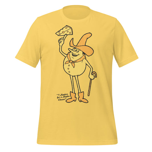 A yellow retro short sleeve t-shirt that says "I Hanker for a Hunka Cheese!" with  an image of a cheese cowboy man with a hat, a scarf, a cane, and boots holding a piece of cheese with holes. Refers to Timer from the series 'Time for Timer'.