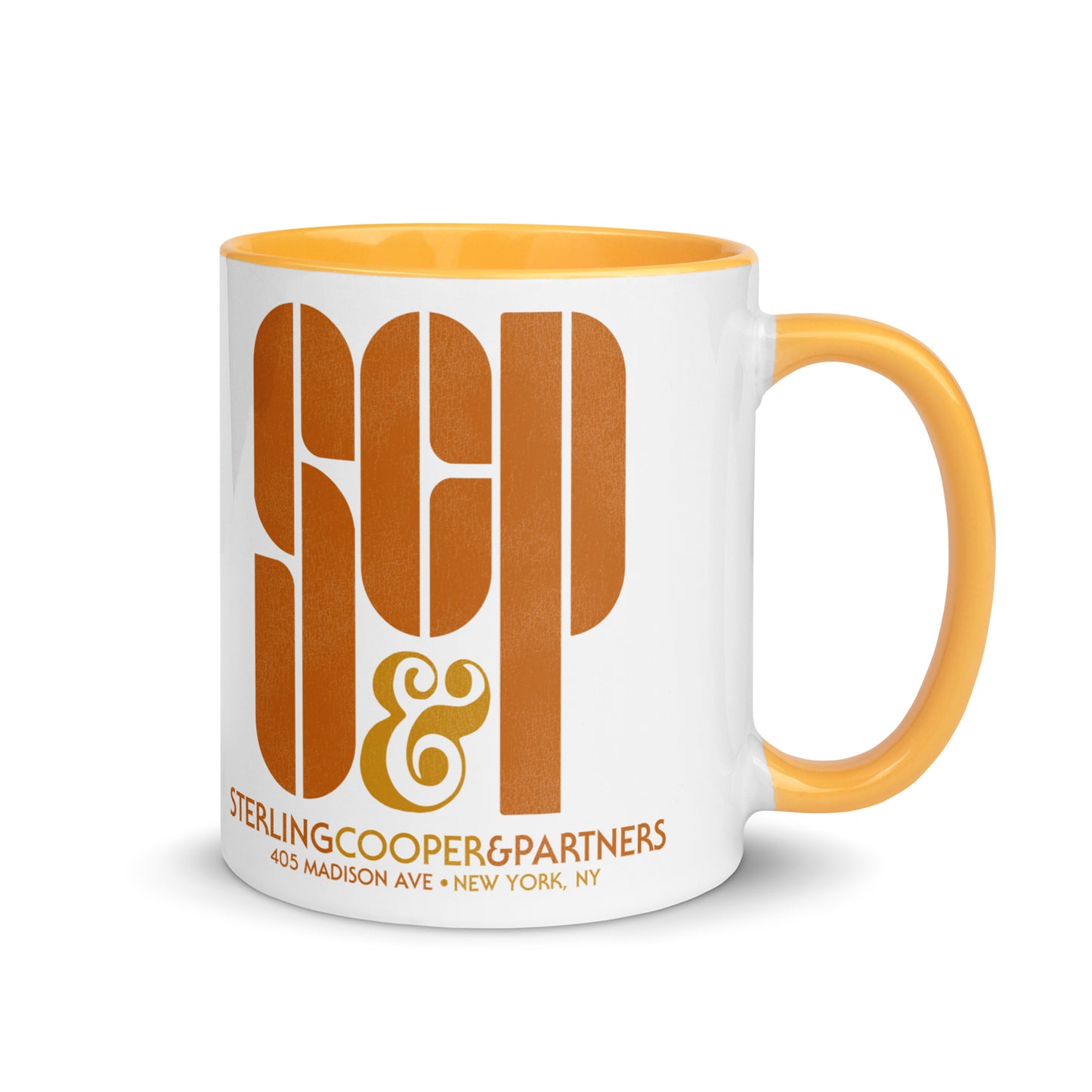A vintage white ceramic mug with a yellow handle and yellow inside. Says SCP & Sterling Cooper & Partners, the name of the advertising agency in Mad Men. The address reads 405 Madison Ave + New York, NY.