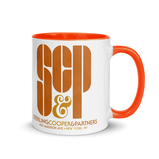 A white ceramic vintage mug with bright orange handle and insides. The mug reads SCP & Sterling Cooper & Partners and 405 Madison Ave + New York, NY. References the advertising firm from Mad Men.
