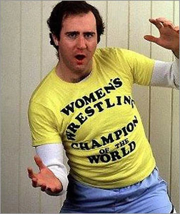 a man in a yellow shirt is holding his arms out