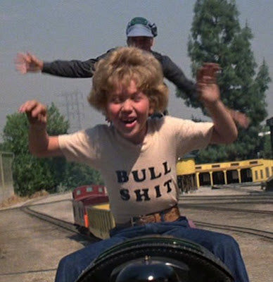 a man riding on the back of a motorcycle next to a woman