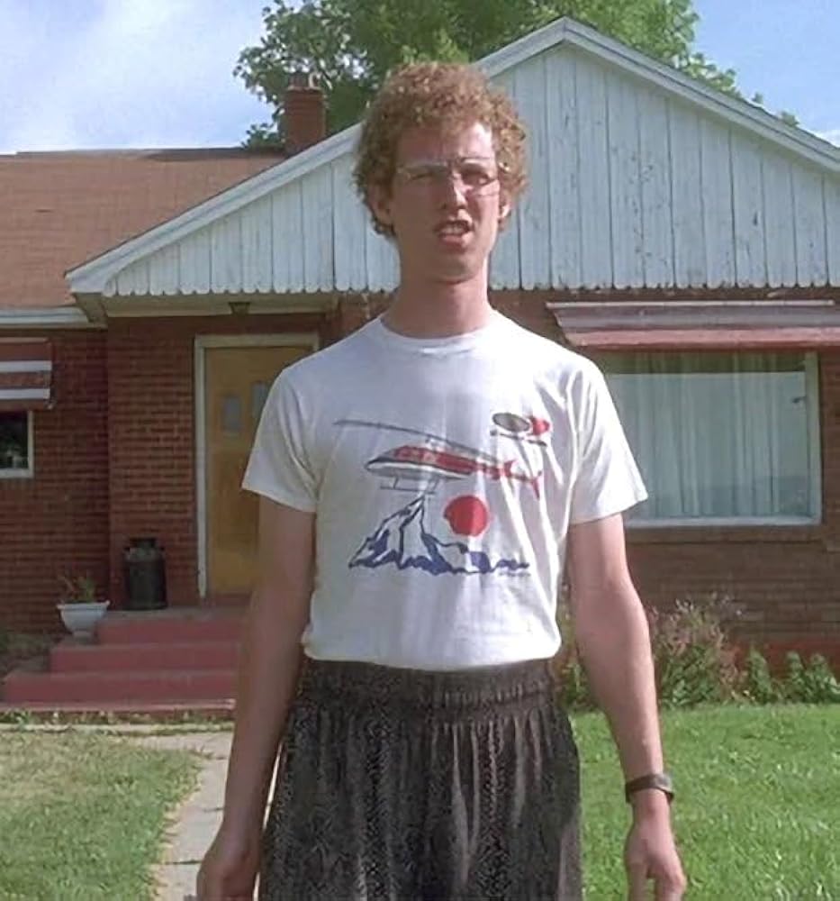 a young man standing in front of a house