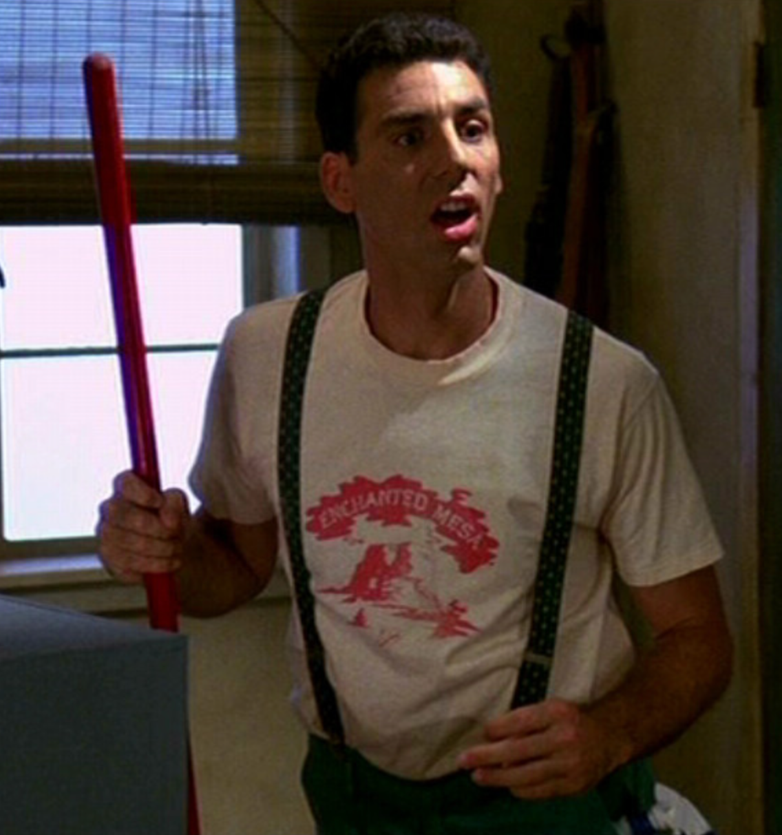 a man holding a large red object in his hand