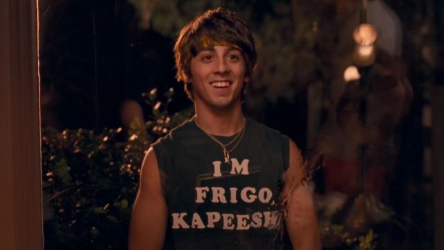 a man in a tank top smiling at the camera
