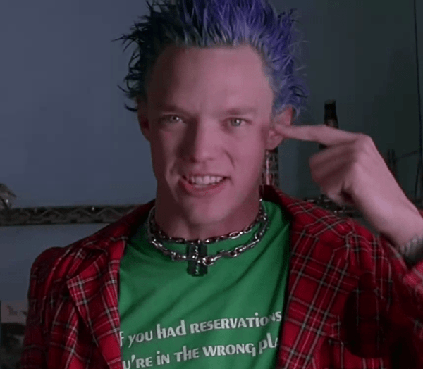 a man with blue hair wearing a green shirt