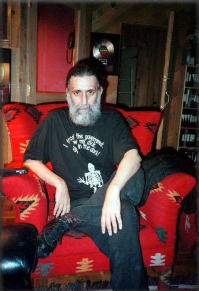 a man sitting on top of a red couch