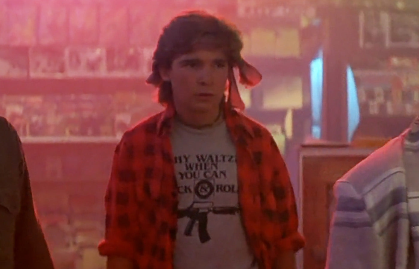a young man with a red jacket and a white t - shirt