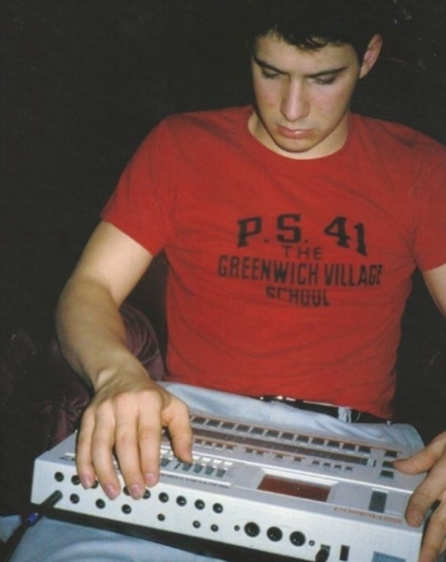 a man in a red shirt is playing a keyboard