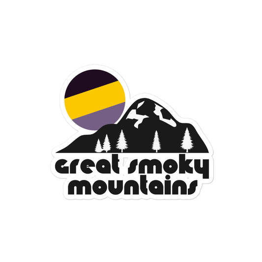 A retro kiss cut sticker that says Great Smoky Mountains with the image of a mountain, some pine trees, and a striped yellow, purple, and black sun setting in the distance, referencing the Great Smoky Mountains National Park in the Appalachian Mountains. 