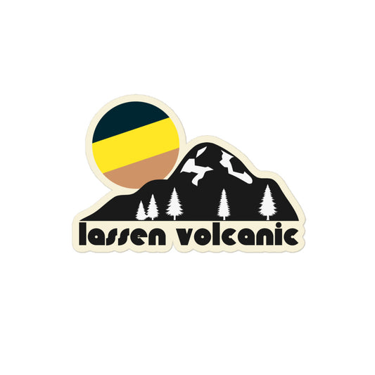 A vintage kiss cut sticker that says "Lassen Volcanic" underneath a mountain with beautiful pine trees and a tricolored black, yellow, and tan sun. References California's Lassen Volcanic National Park, a camping, backpacking, and hiking destination famous for Lassen Peak, one of the largest plug dome volcanoes on earth. 