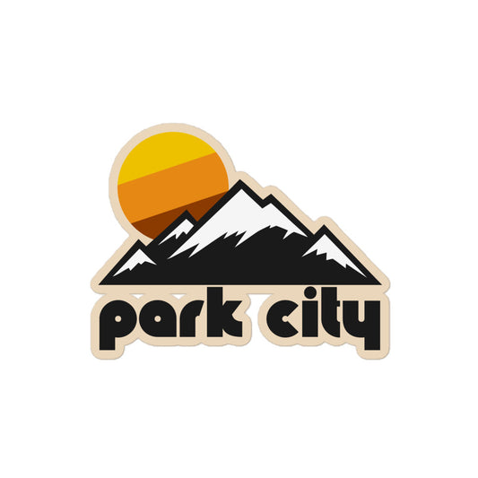 A retro, vintage Park City kiss cut sticker with the image of a mountainous landscape, the mountaintops covered with a dusting of white snow, and a setting yellow, orange, and brown warm toned sun, referencing Park City Mountain Resort, a popular destination for skiers and snowboarders. 