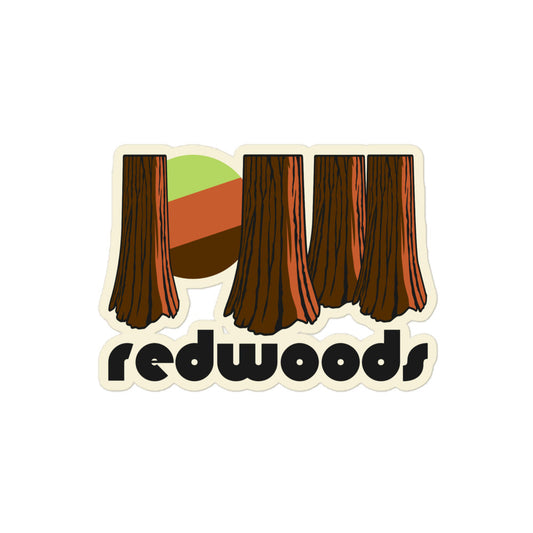 A retro kiss cut sticker that says 'redwoods' underneath the image of multiple redwood tree trunks, a green/brown sun peaking through the forest, referencing Redwood National and State Parks in California. 