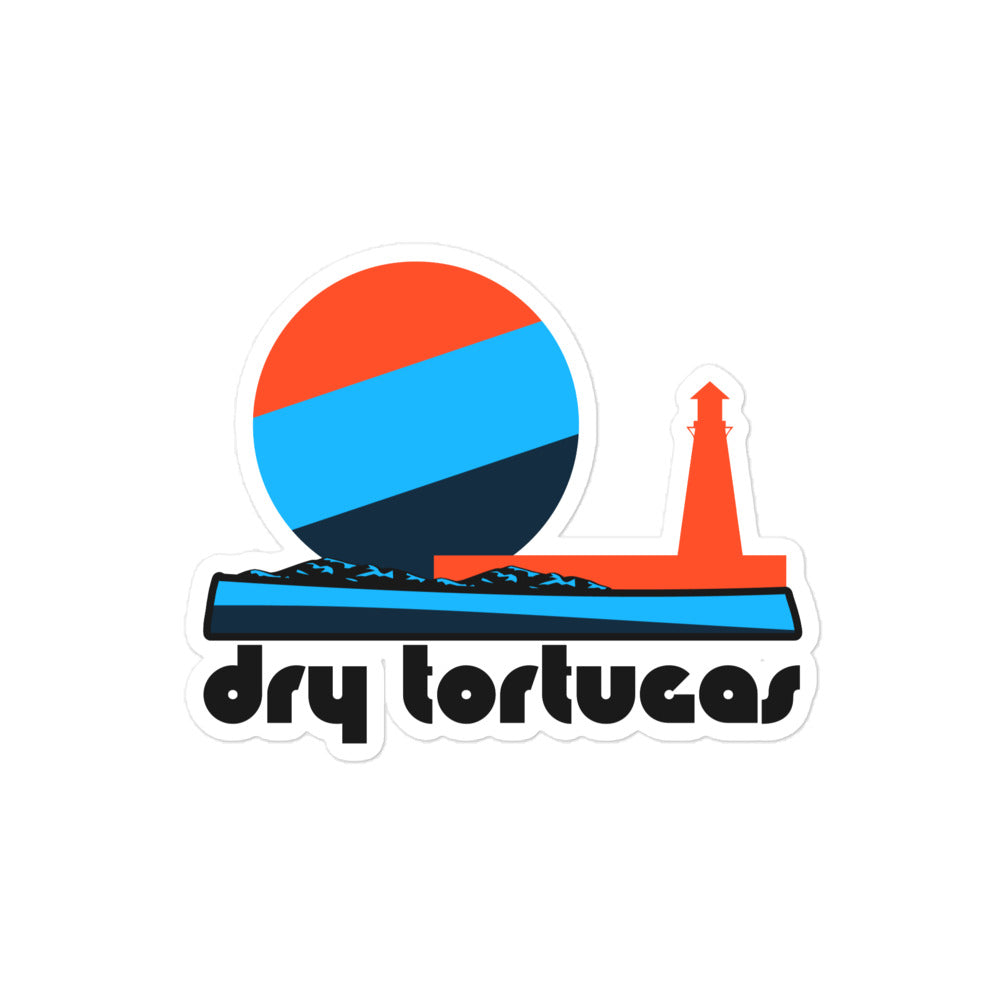 A retro kiss cut sticker that says "Dry Tortugas" under the image of a tricolored red, blue, and navy sun, setting over a waterfront with a red lighthouse. In references to Florida's Dry Tortugas National Park near Key West, filled with picturesque islands and known for Fort Jefferson. 