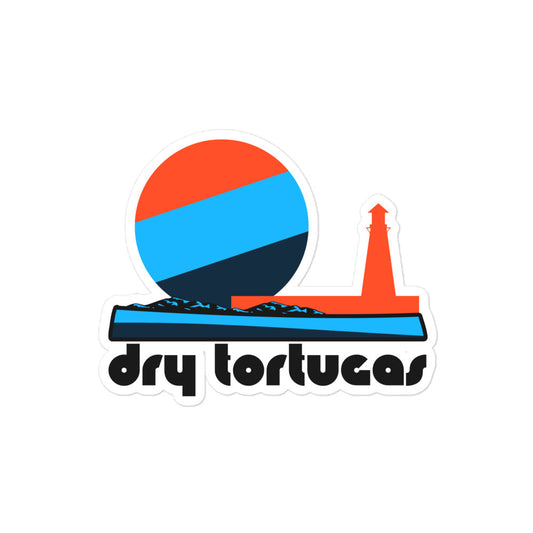 A retro kiss cut sticker that says "Dry Tortugas" under the image of a tricolored red, blue, and navy sun, setting over a waterfront with a red lighthouse. In references to Florida's Dry Tortugas National Park near Key West, filled with picturesque islands and known for Fort Jefferson. 