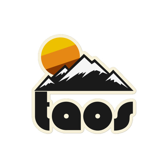 A vintage style kiss cut sticker that says "Taos" in large black block letters underneath a picturesque mountain and setting sun landscape. References Taos Ski Valley in Taos County, New Mexico. 