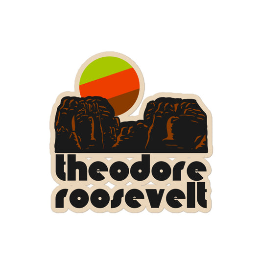 A retro, tourist kiss cut sticker with the image of a brown, red rock natural landscape under a green, red, and brown sun, and that says "Theodore Roosevelt", referencing the national park in the North Dakota Badlands. 