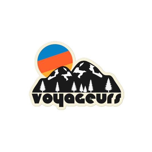 A Voyageurs National Park vintage kiss cut sticker with an image of mountains, pine trees, and a bright blue/orange/yellow sun behind, referencing the Minnesotan national park next to the Canadian border. 