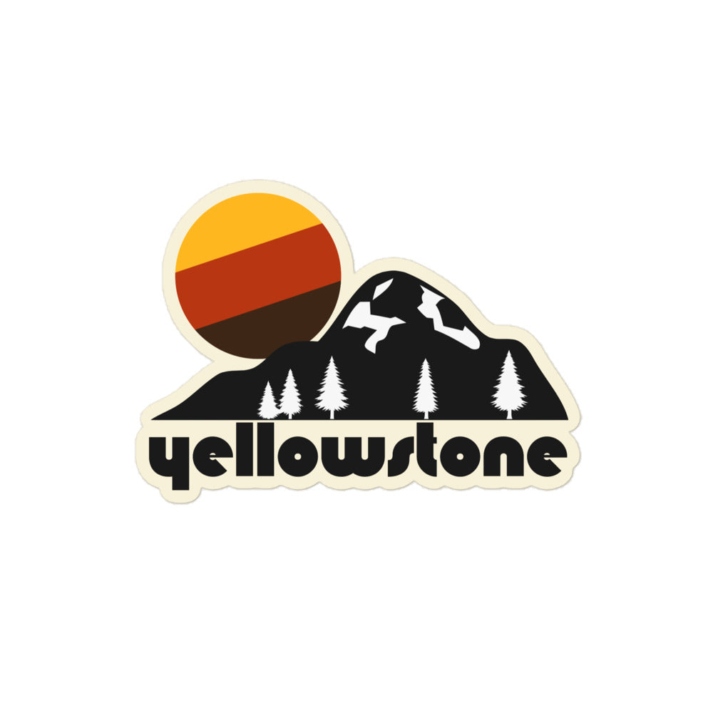 A vintage Yellowstone kiss cut sticker with a mountain landscape and pine trees with a yellow, red, and brown sun setting. References one of the most famous national parks in the United States, locate in Wyoming, atop a volcanic hot spot and known for its hot springs and geysers.  