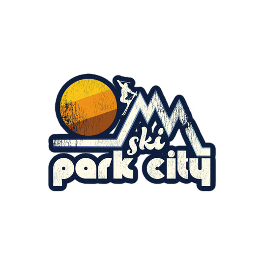 A retro "Ski Park City" kiss cut sticker with the image of a skier skiing down one of three tall, pointed mountain peaks as a brown, orange, and yellow sun sets. References the Utah city known for its resorts - like Park City Mountain Resort and Deer Valley Resort - and for the Wasatch Mountains. 