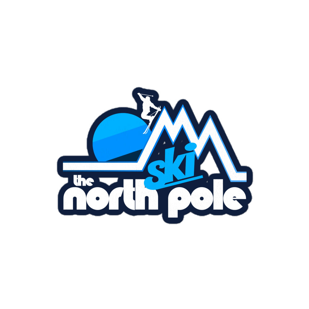 A vintage "Ski the North Pole" kiss cut sticker in blue and white colors with the image of a person skiing down steep mountain cliffs in front of a setting sun. 