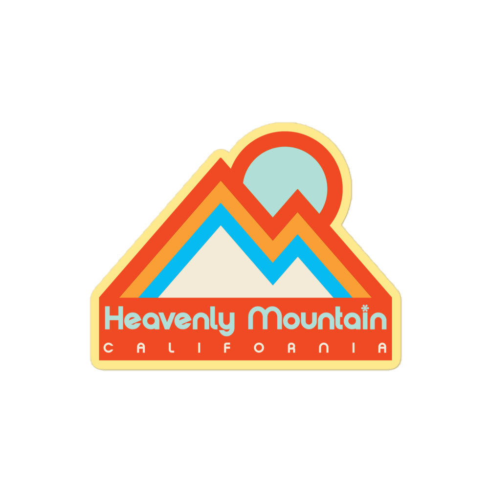A retro Heavenly Mountain, California kiss cut sticker with an image of two mountain peaks under a sun in blue and orange hues. 