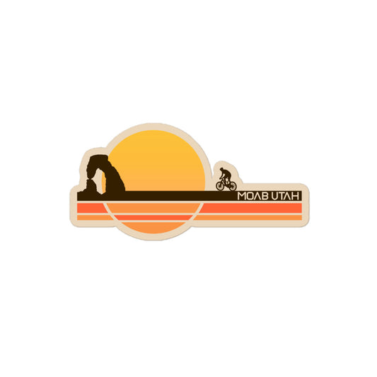 A retro kiss cut Moab Utah sticker with the image of a yellow sun over a brown, orange, and yellow earth with a cyclist riding towards the famous Delicate Arch, also known as "The Arch", from Arches National Park. 