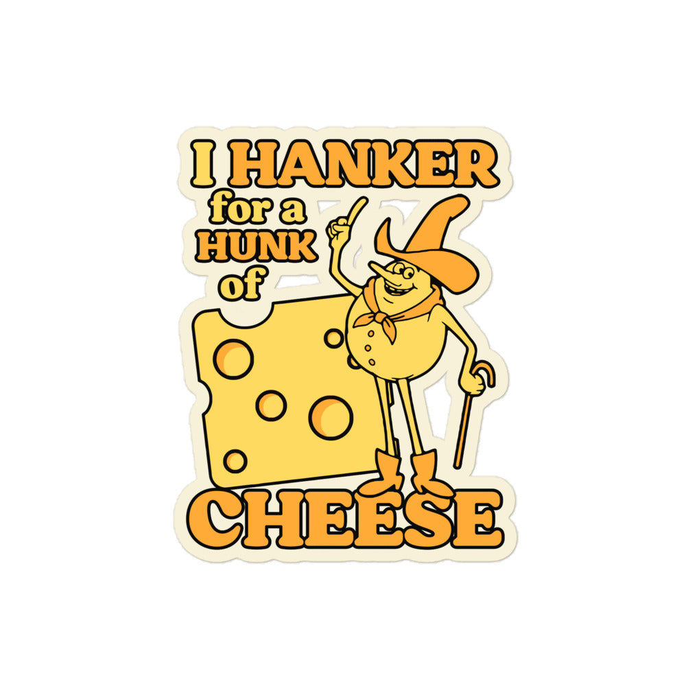 A retro kiss cut sticker that says "I hanker for a hunk of cheese" with the image of a piece of cheese with holes and a cheese yellow cowboy looking man. In reference to the song from the "Time for Timer" ABC After School Special in the 1970s. 