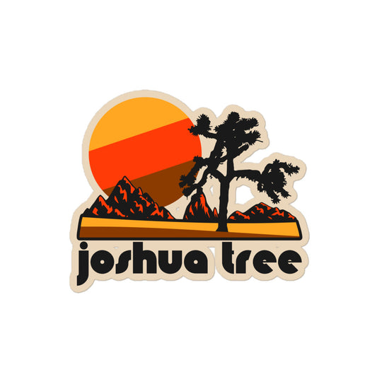 A kiss-cut sticker with the words "Joshua Tree", referring to the national park, and a yucca brevifolia tree with a red mountain landscape and yellow, red, and brown sun. 