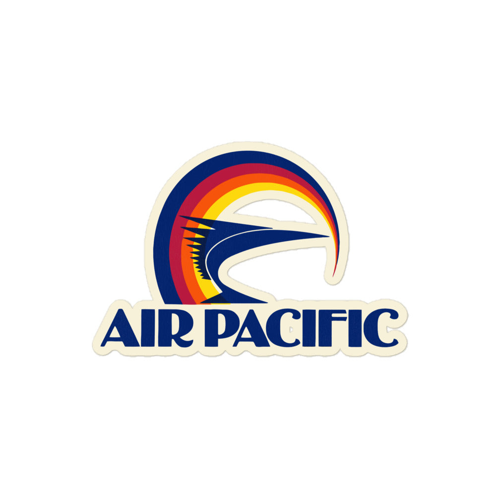 A kiss cut sticker reading "Air Pacific" with the airline's logo of circular blue, magenta, orang, and yellow lines with a blue fish. 