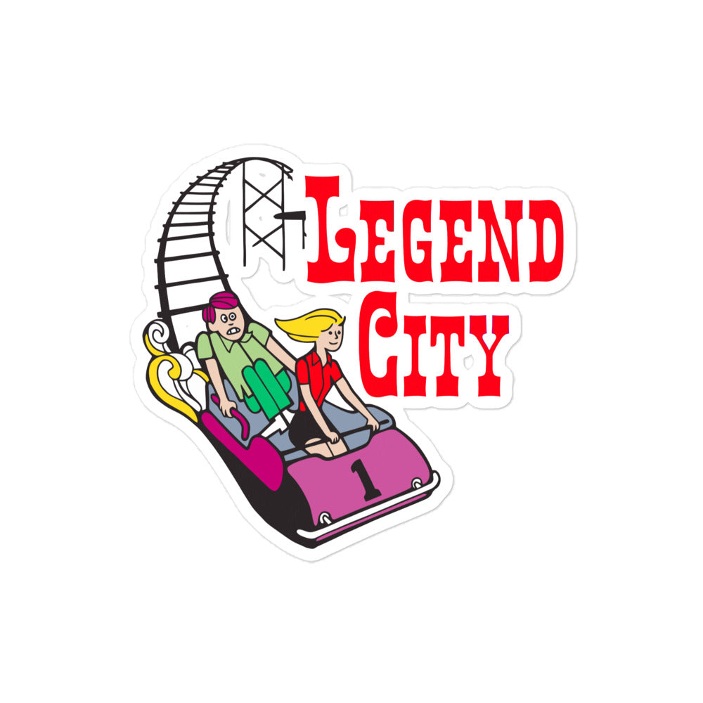 A retro kiss cut sticker that says "Legend City" in red letters with image of two people riding a pink rollercoaster. 