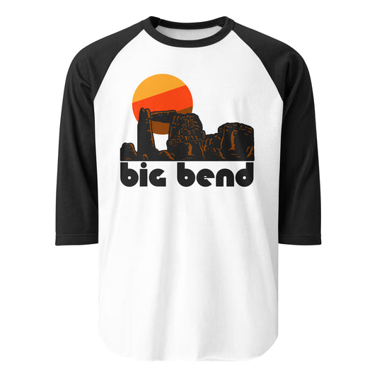 A three quarter sleeve black and white vintage raglan style shirt that says 'big bend' with the image of multiple southwestern red rock formations, including arches, hills, and spires, underneath a rising yellow, orange, and brown sun. In reference to Big Bend National Park in Texas with breathtaking hikes like Lost Mine Trail, Santa Elena Canyon Trail, and South Rim Trail, and beautiful views in the Chisos Mountains and of the Rio Grande. 