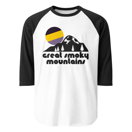 A three quarter sleeve black and white raglan retro shirt which says "Great Smoky Mountains" and includes a mountain range, pine tree, and shining sun image in reference to the Great Smoky Mountains National Park, located in North Carolina and Tennessee, including some of eastern North America's tallest mountains like Kuwohi, Mount Le Conte, and Mount Guyot. 