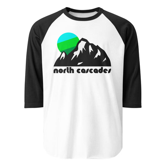 A black and white three quarter sleeve retro raglan style shirt that says "north cascades" underneath the image of multiple mountain peaks with snowy sides and a radiant tricolored sun in greens and blues. References Washington's Cascades  Range and North Cascades National Park, a tourist destination for hikers and skiers.  