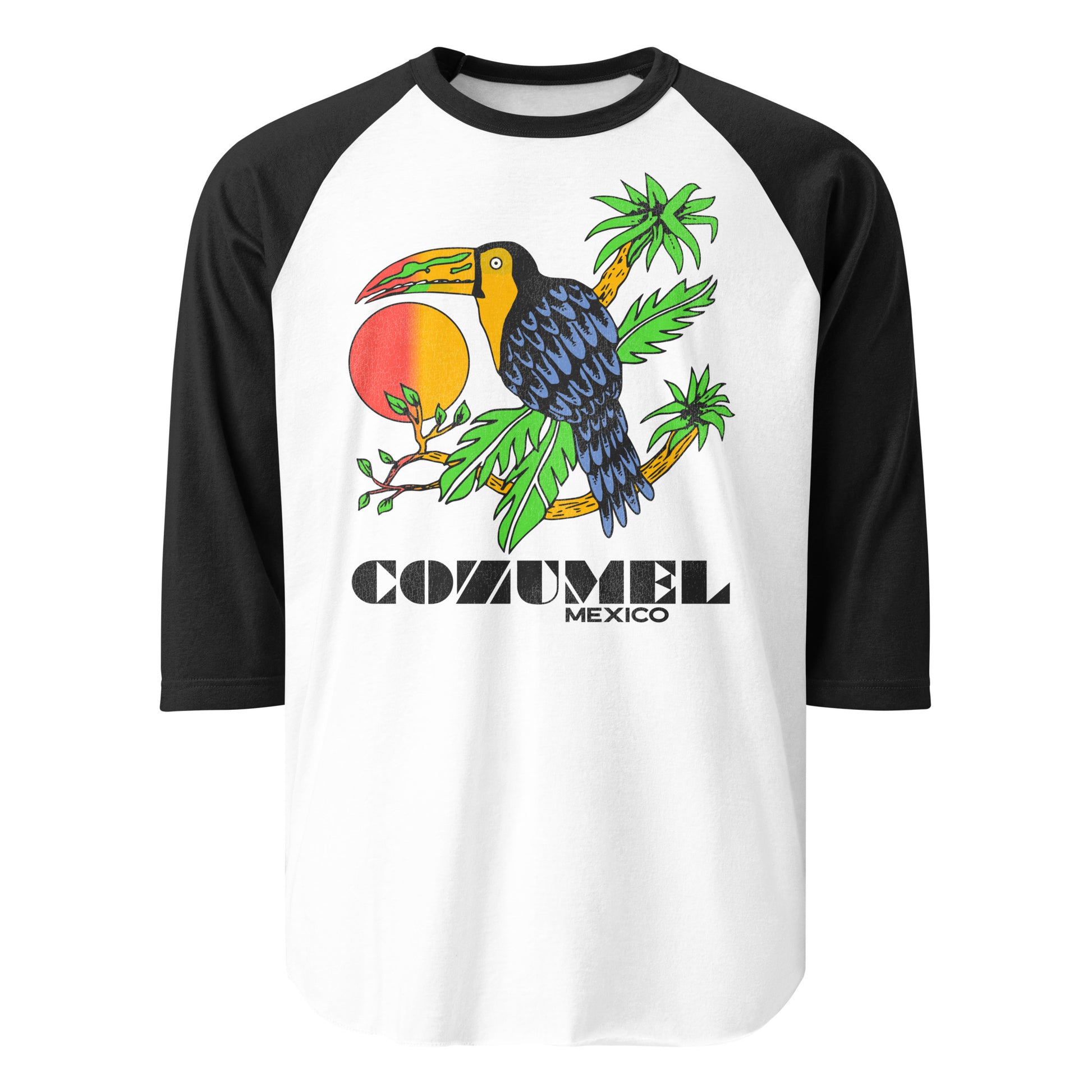 A vintage raglan style three quarter sleeve black and white tourist shirt that says Cozumel Mexico, referring to the popular cruise ship destination in the Yucatán Peninsula. Image of tropical bird sitting on brown palm tree branches with green leaves. Hombre orange and red sun is in the back. 