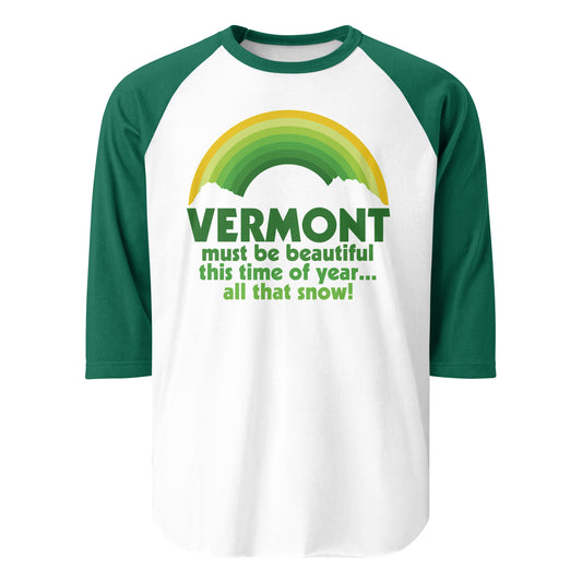 A kelly green and white 3/4 sleeve retro raglan style shirt with the image of a rainbow in various shades of gold and green, stopped by the outline of two white clouds. Includes the famous quote from 'White Christmas', the 1954 musical comedy movie:  "Vermont must be beautiful this time of year... all that snow!" 